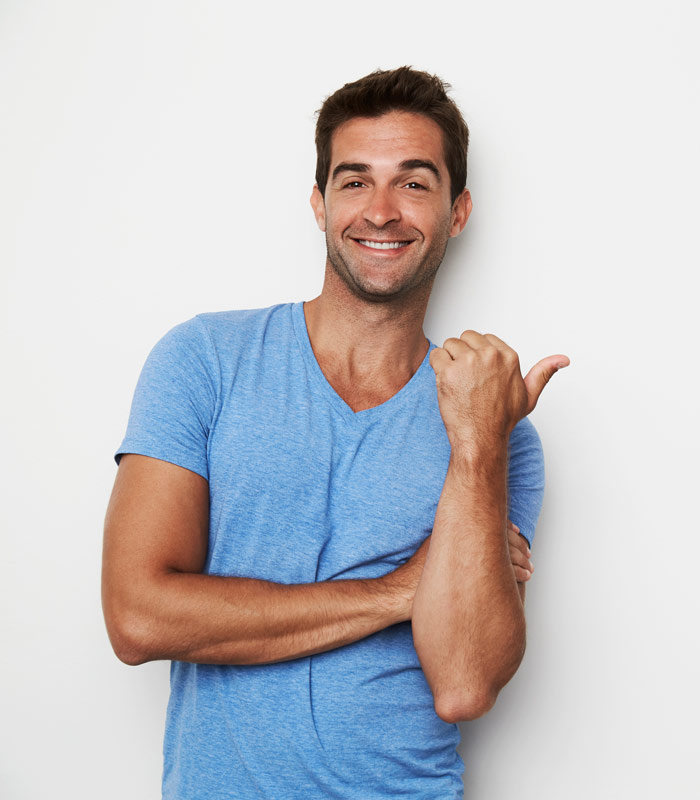 man in blue shirt pointing with his thumb